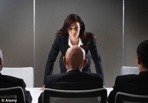 Woman facing down a man in the boardroom
