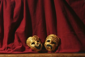 Comedy and Tragedy Masks on a Stage