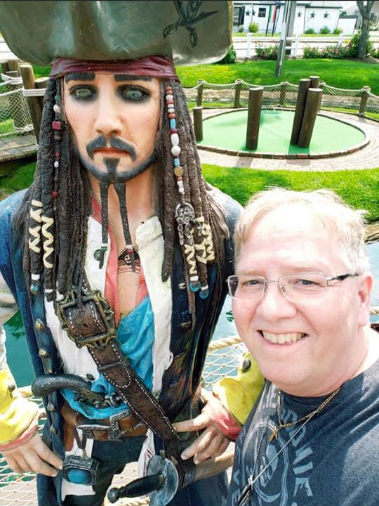 Bob Scharn standing with statue of Captain Jack Sparrow